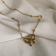 Golden Whisper Bow Necklace